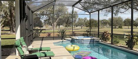 Large pool/spa - Table 5 chairs 2 lounges, bar, refrig, pool floats etc
