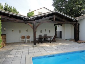 The pool area has a shaded patio & kitchen  - and a gate with child-proof lock