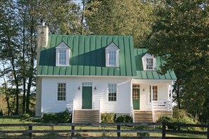 Front of house showing covered porch on the right. Den is inside porch door.