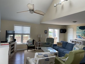 Sliding door access from den to large deck; deck stairwell to parking bay