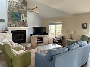 Large den with gas log fireplace and comfortable seating