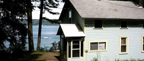 Rear view of Twin Pines w/parking behind cottage and Cayuga Lake to the east.