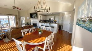 Vaulted ceilings. Dining room table seats six with additional seating in kitchen