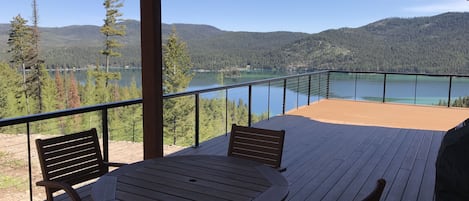 Table located in covered area of deck w/ BBQ grill