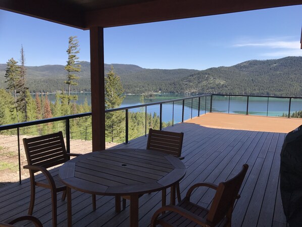 Table located in covered area of deck w/ BBQ grill