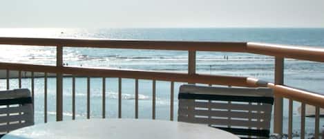 Condo balcony overlooks ocean, tidal creek and miles of undeveloped beach.