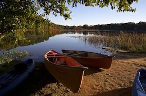 The beach area with canoes and kayaks