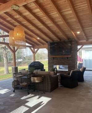 Smart tv above double sided gas fireplace. 