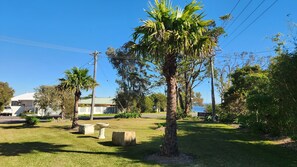 Large front lawn fenced by garden