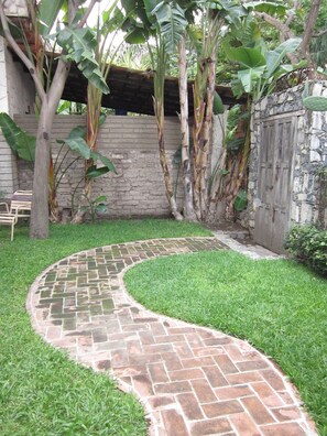View out the back door, off bedroom.  Adobe and stone walled garden.
