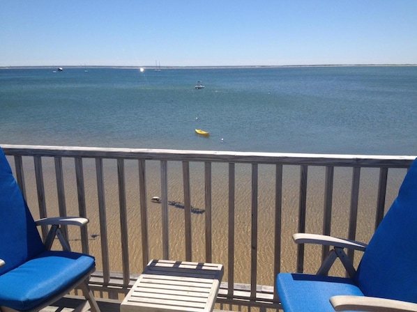 Exclusive use deck with teak furniture overlooking Provincetown Harbor.