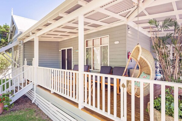  Enjoy morning coffee or an evening drink on the wide verandah, with comfortable seating and a tranquil outlook over the foreshore park.