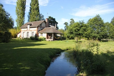 Ancient Normanbarn  with piano peacefully situated on the river Andelle
