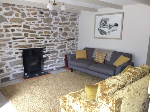 Lounge with wood burner and door leading to snug/office room
