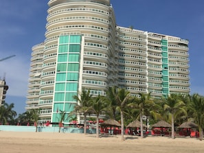 From beach, looking at building, right side, 8th floor where the shade is.