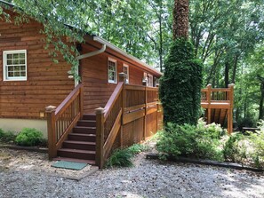 Parking area with stairs to front door and deck