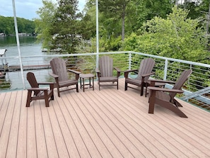 4 Adirondack chairs and tables on the top deck with sun sail