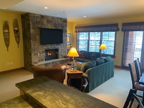 Warm and inviting living room with new 65" Flat screen TV above the fireplace.