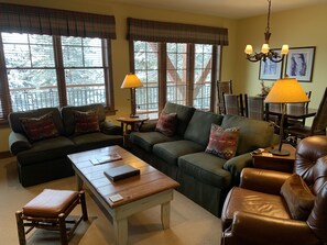 Living room with a view of dining room in the back.