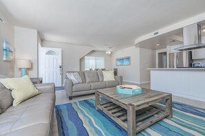 Living room of this downstairs unit looks out to front ocean view patio, with easy access through sliding glass doors.
                