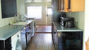 Kitchen equipped with bosch dishwasher, thermador fridge, stove and microwave