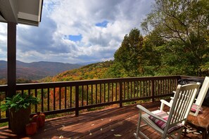 Enjoy the view!  2 rocking chairs and a round dining table with 6 comfy chairs