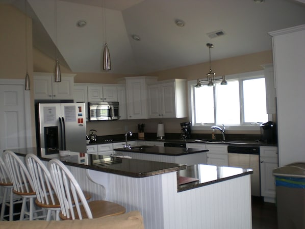 Spacious kitchen with serving breakfast bar.