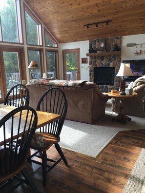 great room facing fireplace and lake