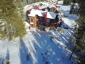 drone pic uphill (west) elevation; shows ski-out to right of house; hot tub
