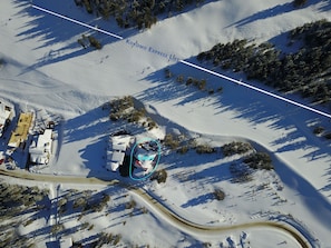 drone pic of true ski-in (down short hill) and out (path down and to left)