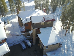 drone pic front elevation; also shows ski-in path behind house