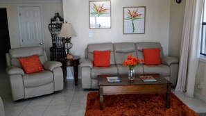 Modern Living Room with Leather Reclining/ Rocking Chair & 2 Recliners on sofa.