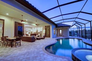 Pool and lanai. Pool has 5 lounge chairs.