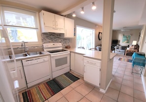 Full size kitchen and appliances with counter seating