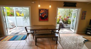 Large dining area with two sets of doors to deck and yard