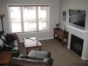 Living Room with view of Trout Pond and 48" Flat Panel SMART TV above Fireplace