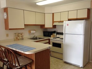 Kitchen.  Fully stocked with dishes, glasses, utensils and cookware.