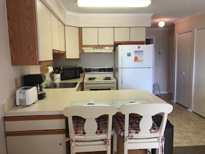 Kitchen view.  Fully stocked with dishes, glassware, utensils and cookware.