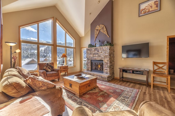 Unit 5093 living room--stone fireplace, flat screen TV, and Queen fold out sofa.