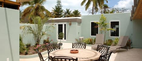 Private atrium Patio garden with outside dining area and grill