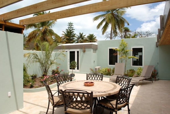 Private atrium Patio garden with outside dining area and grill