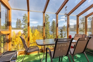 Sunroom with patio table also serves as entry to home