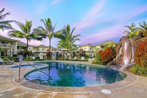Beautiful pool with waterfall, BBQs, lounge chairs, hot tub, umbrellas