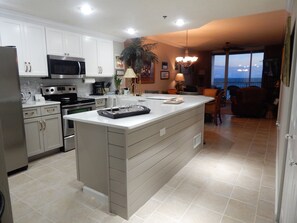 Kitchen with quartz countertops. New farm sink, cabinets, hardware, tile Shiplap