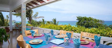 Large porch overlooking the beautiful ocean of Silver Sands with outside table