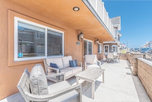 View of the home's exterior, located on a corner lot, just one home from the sand.