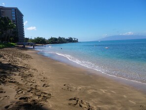 The warm water & gentle surf at the beach right in front of our 5th floor place.