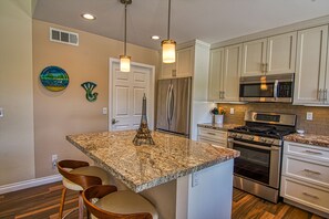 The kitchen island is a great place for laptops with outlets on both ends.