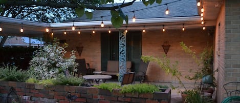 Relaxing front patio with glider swing and bistro table