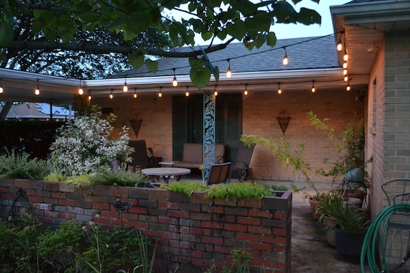 Relaxing front patio with glider swing and bistro table